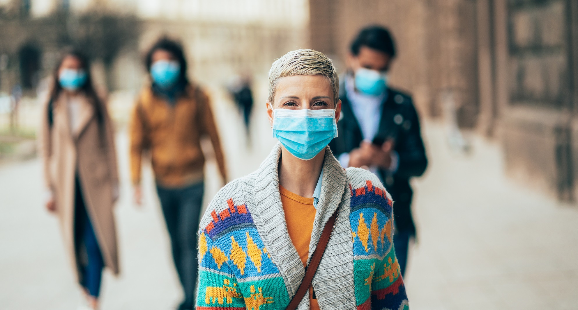 Lady in street with a face mask on